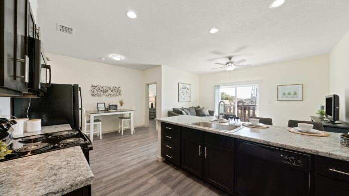 Boerne Apartments - Garden Creek Apartments - Kitchen with Wood Style Flooring, Large Kitchen Island, and High Ceilings